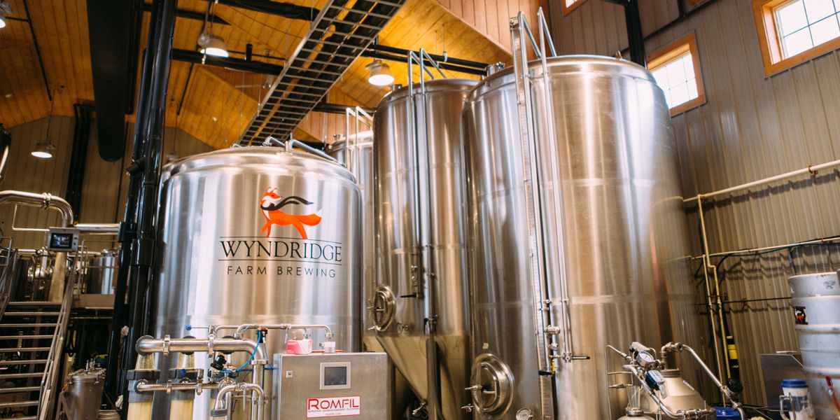 Brewhouse tanks with the Wyndridge Farm Brewing fox logo